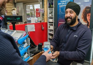 Handepay Supermarket Customer using Handepay Card Machine to take payment