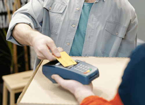 Person using card on card machine as contactless payment