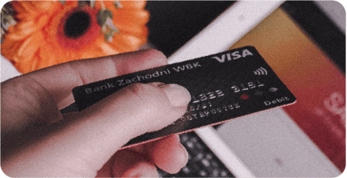 Person holding a visa debit card