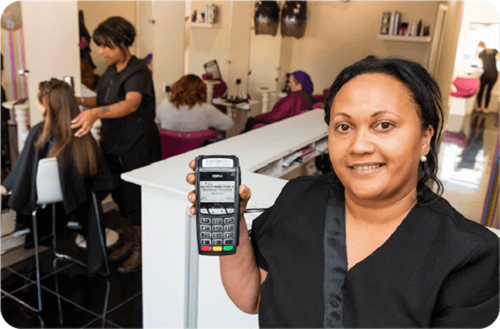 Staff member at Head Kandy holding Handepay Card Payment Machine