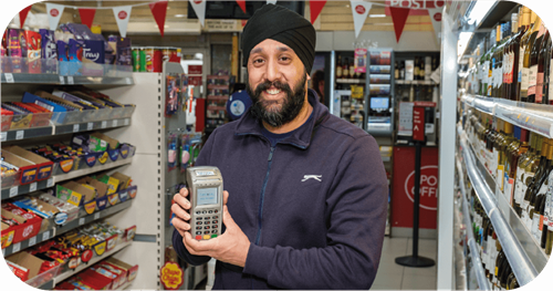 Shop owner holding Handepay Card Payment Machine