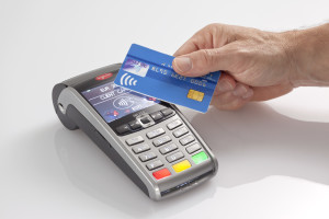 Holding a payment card over a machine for contactless payment