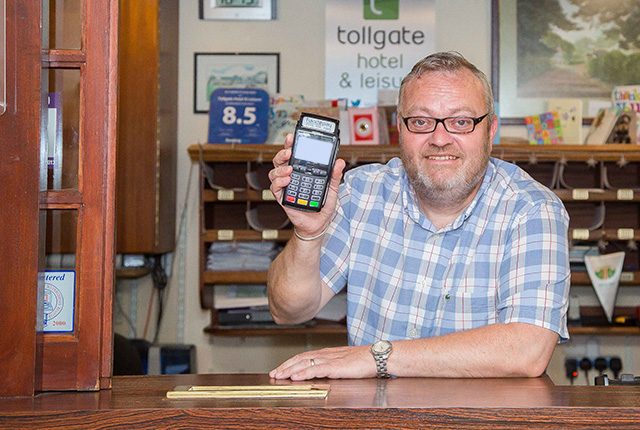 Tollgate Hotel & Leisure man holding Handepay card payment machine