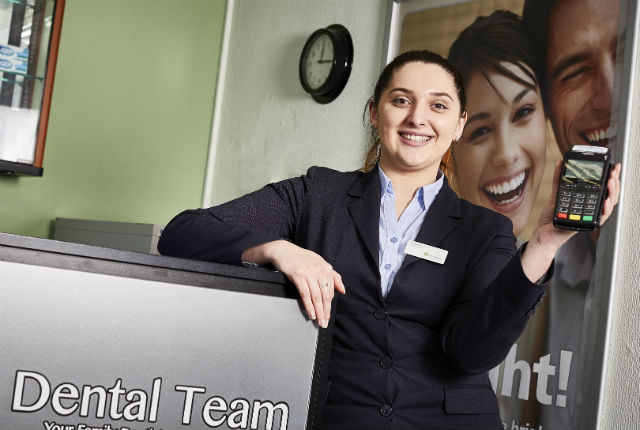 Dental Team staff member with Handepay card machine