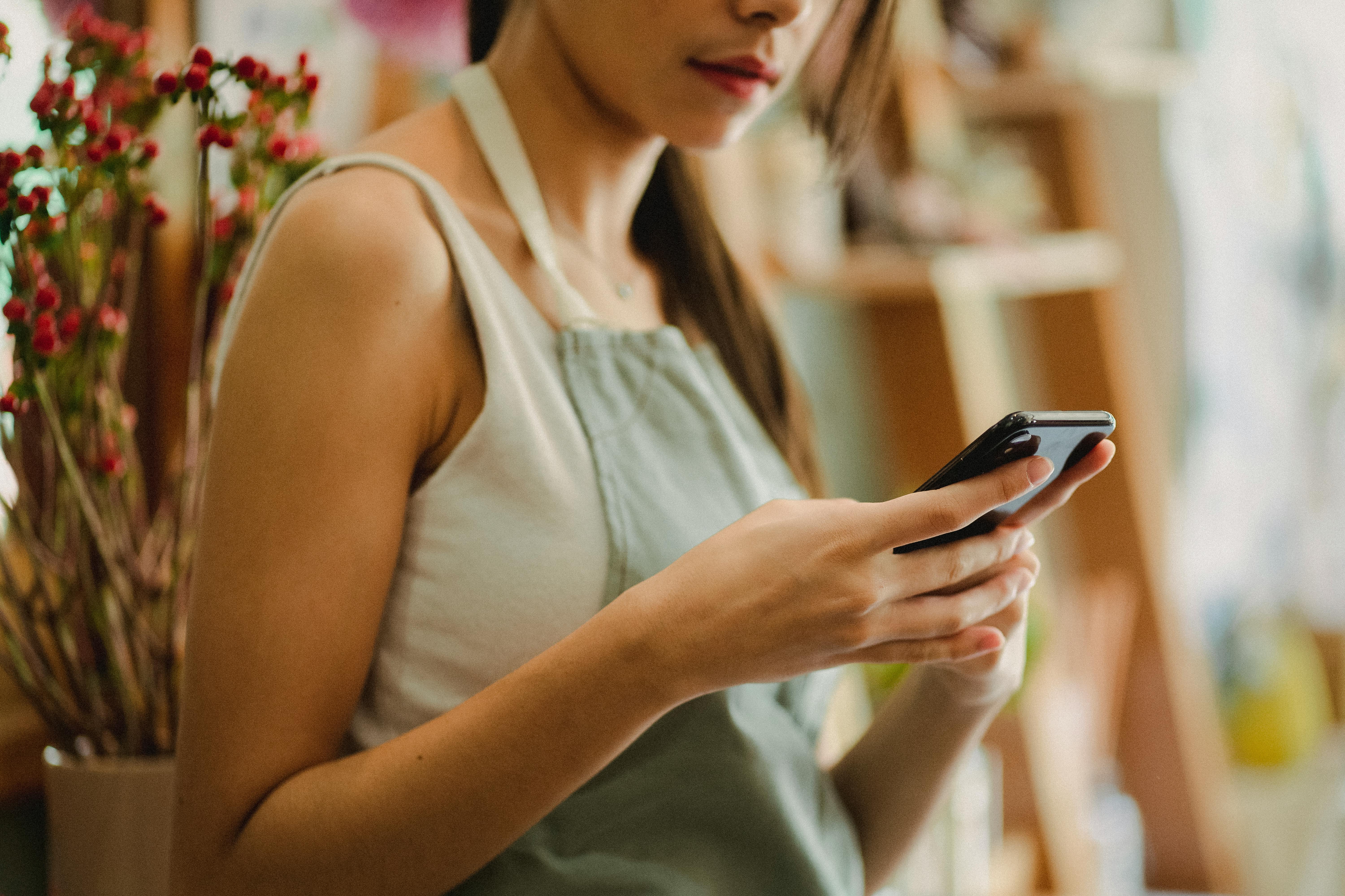 Employee using phone to access Merchant Mobile App