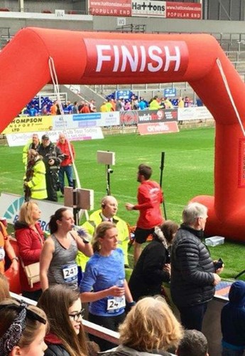Crossing the finish line of St Helens 10K
