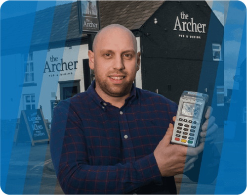 Owner of The Archer holding Handepay Card Payment Machine