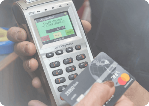 Card Payment Machine being held showing amount due with person holding card payment