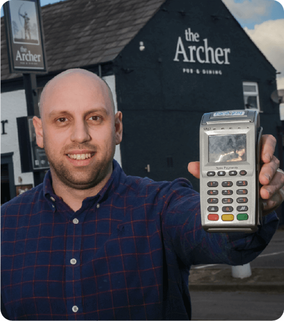 Owner of The Archer holding Handepay Card Payment Machine