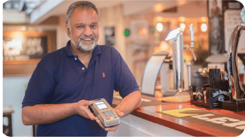 Owner of LEIF Tearooms and Piano with card payment machine in hand