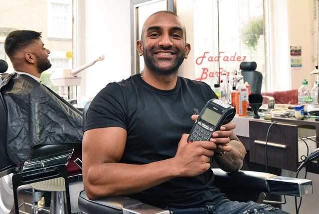 Fadez Barbers holding Handepay Card Payment Machine