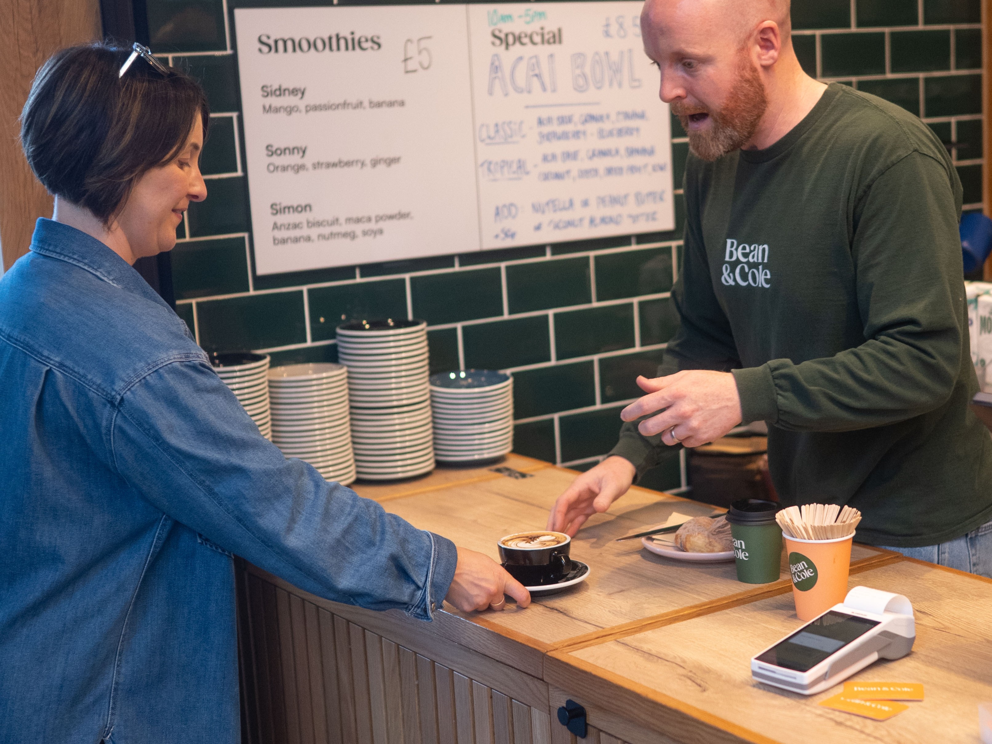 Serving a customer a coffee