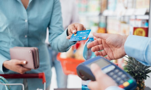 Card being handed over to pay for items in a shop