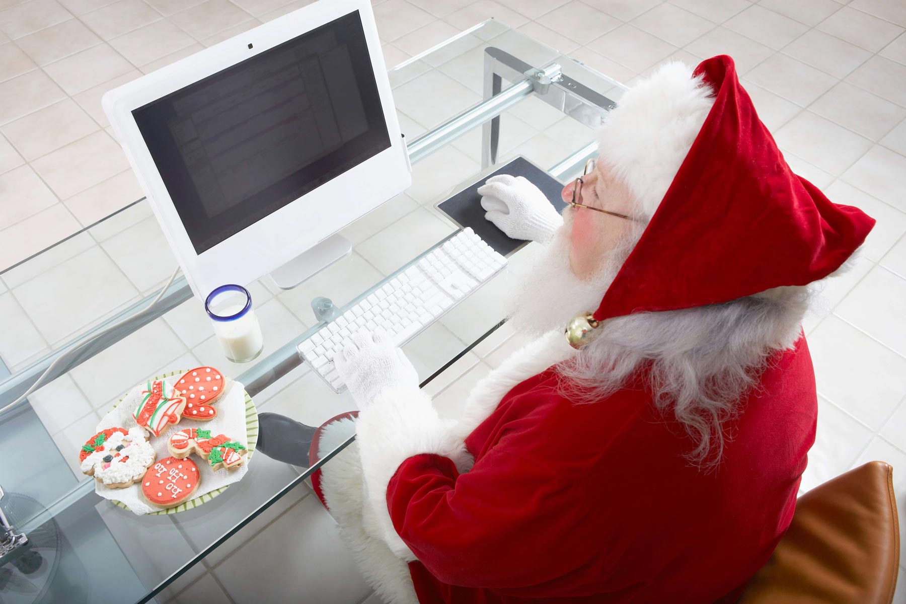 Santa sitting at desk on a PC