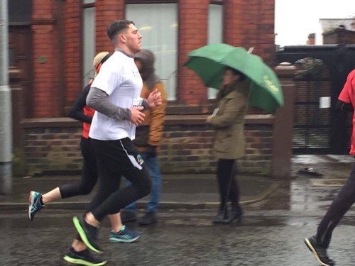 Handepay staff running in the rain for St Helens 10K