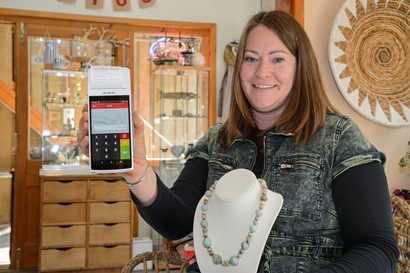 Balm Jewellery Owner holding card reader machine