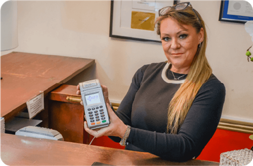 Andrea Murdock from Hotel Commodore holding Handepay Card Machine